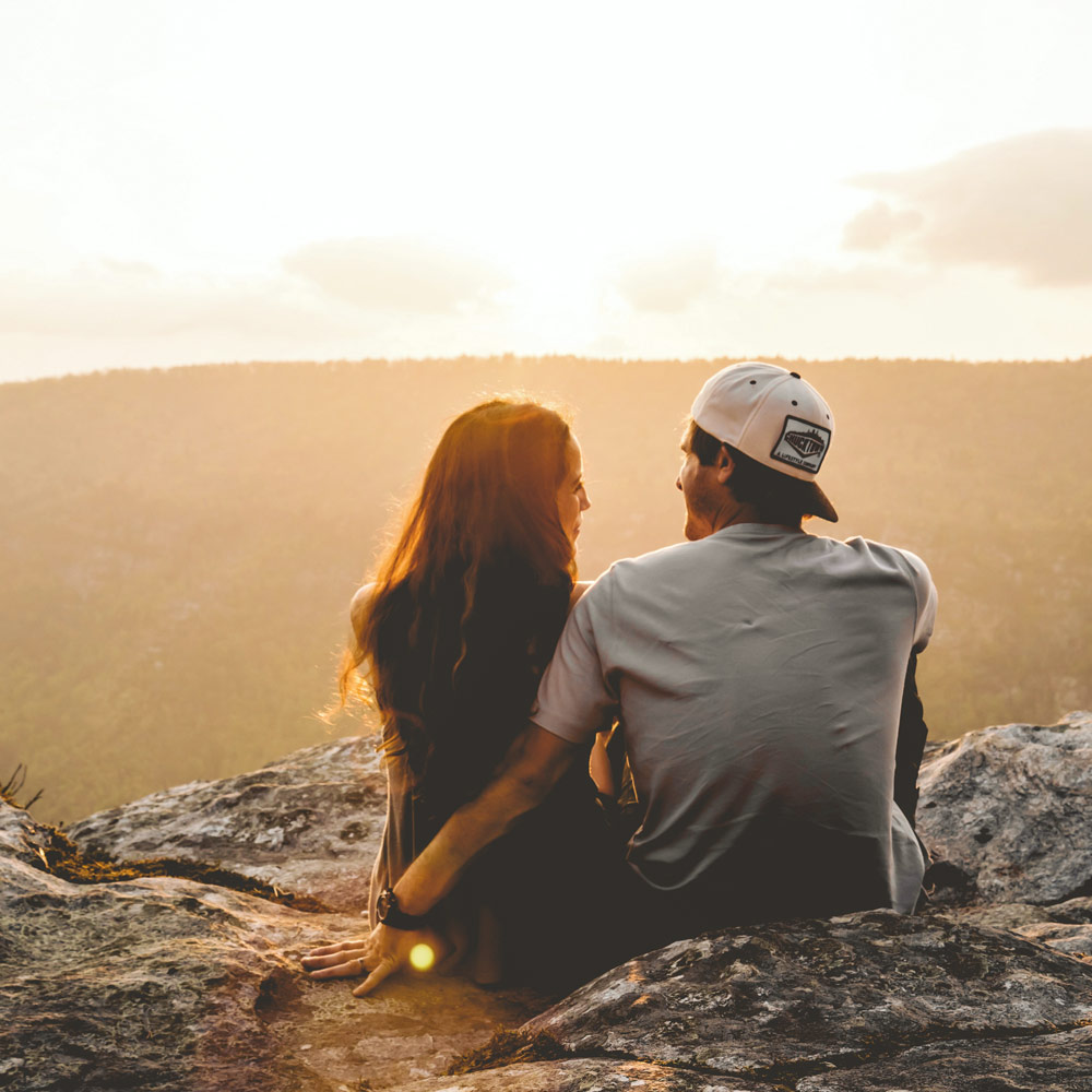 couple sitting together at sunset